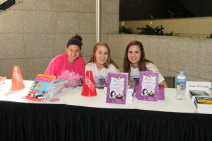 Teen volunteers at the author table.